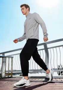 Outdoor low-angle shot of men's retro casual sneakers with thick soles and sporty outfit