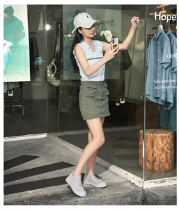 Breathable grey mesh hiking sneakers paired with an olive utility skirt for summer