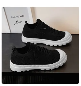 Detail view of breathable black mesh upper and thick white rubber sole on sneakers