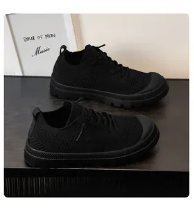 Close-up of all-black breathable mesh sneakers with non-slip thick rubber soles