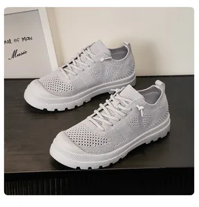 Close-up of gray breathable mesh sneakers showing slip-resistant white rubber soles and texture