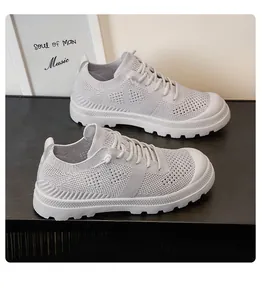 Macro detail of light grey mesh hiking shoes showing breathable knit fabric and thick rubber sole