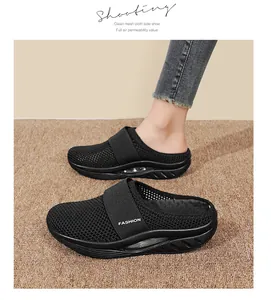 Detail of black mesh mule sneakers with fashion strap and visible air cushion sole