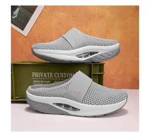 Detail view of the breathable mesh upper and air cushion sole of women's wedge mules