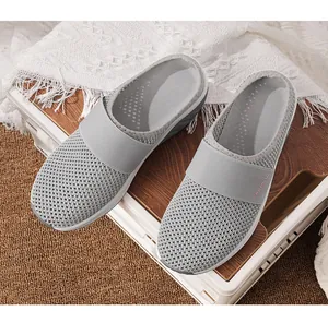 Close-up of grey breathable mesh mules with fashion elastic strap and thick platform sole