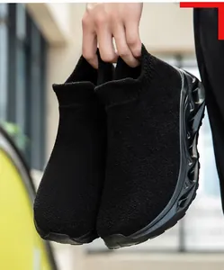 Macro detail of black knit sock sneakers featuring a unique wavy hollow-out sole