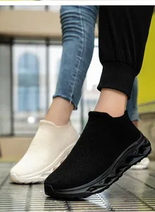 Outdoor shot showing textures of fly-knit slip-on sneakers with hollow soles