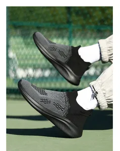 Detail view of grey and black knit walking shoes with thick slip resistant soles