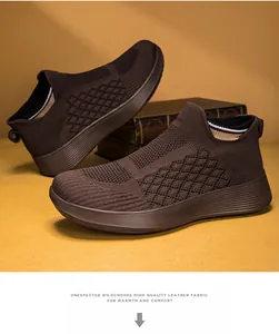Detail of dark brown breathable knit sneakers with textured sole on vintage books