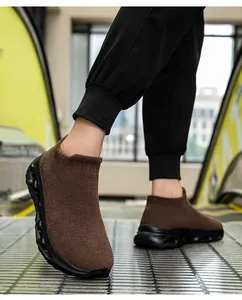 Side view of brown flyknit sock sneaker with cushioned thick sole on an escalator