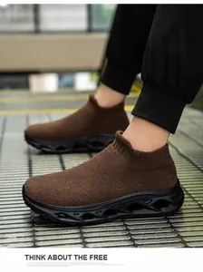 Detail view of brown knit sock sneaker featuring a black hollow-out thick sole design