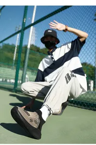 Detail of breathable knit hiking shoes with thick non-slip soles in khaki and black