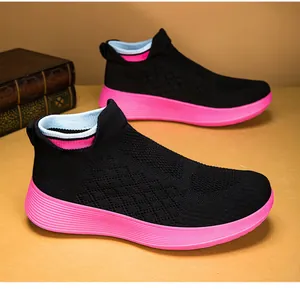 Detail of black knit mesh breathable upper and pink cushioning midsole on walking shoes