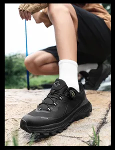 Detail of outdoor hiking shoes with dial-fit lacing system and rugged rubber sole