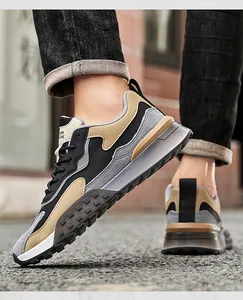 Detail view of stylish men's outdoor sneakers featuring black and khaki patchwork design