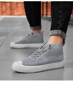 Detailed macro view of the grey knit upper and thick white rubber sole on these shoes