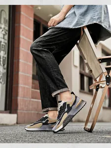 Detail shot of men's low-top outdoor sneakers with gray patchwork and thick rubber soles