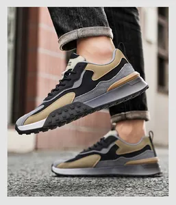 Detailed side view of men's outdoor sneakers with suede texture and multi-layer cushioned sole