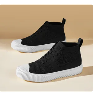 Detail view of black knitted high-top sneakers with white rubber platform soles and laces