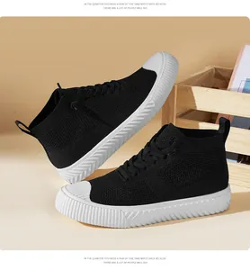 Close-up of high-top knit sneakers with white rubber toe caps and black fabric texture