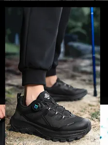 Close-up of black hiking sneakers with dial lacing system and rugged rubber outsoles