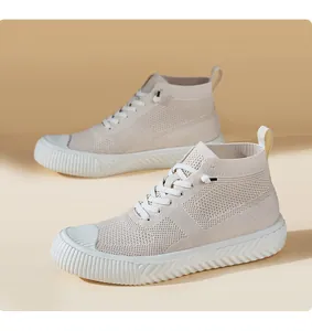 Detail view of beige high-top knit sneakers with breathable texture and thick rubber sole