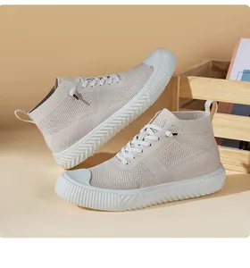Detailed macro of beige knitted high-top sneakers with thick white platform rubber soles