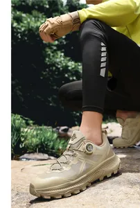 Outdoor hiking shoes with mesh upper and quick-adjust knob system shown on rocky terrain