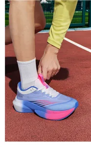 Detailed close-up of breathable mesh running shoes with thick cushioned soles on track