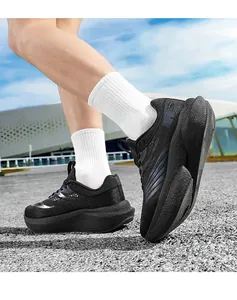 Detailed view of breathable mesh upper and cushioned thick sole on black running shoes