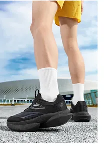Detail showing breathable mesh fabric and cushioned outsole of the black running shoes