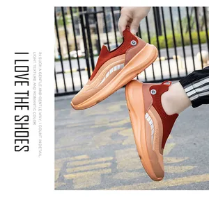 Close-up of orange slip-on knit hiking shoes with shock-absorbing thick soles and breathable mesh