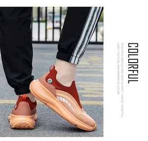 Close-up of orange breathable knit sneakers with thick cushioned EVA sole in action
