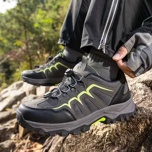 Outdoor hiking shoes in dark grey with green accents and non-slip rubber soles