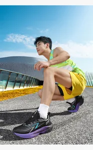 Low-angle outdoor shot of breathable mesh running shoes with thick cushioned soles