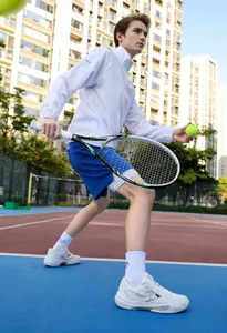 Detail of white tennis shoes with rotary dial laces on professional court
