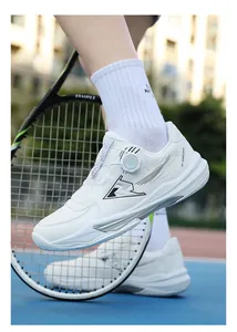 Detail of white mesh tennis shoes with rotary knob buckles on a blue court