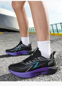 Detail of chunky purple gradient sole and black mesh upper on stylish running sneakers