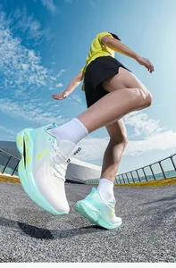 Detailed view of breathable mesh running shoes with mint green and white color block design