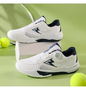 Close-up of white and blue tennis shoe with BOA lacing system on green court court
