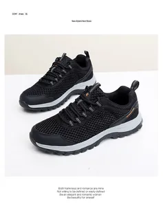 Detail of black mesh breathable hiking shoe with orange accents and thick grey sole