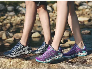 Close-up of breathable mesh water shoes with drainage holes for hiking by a stream