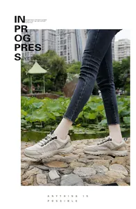 Detail view of breathable beige mesh hiking shoes with durable rubber sole and woven laces