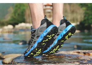Close-up of gray outdoor water shoes with blue rubber soles and anti-slip yellow grips