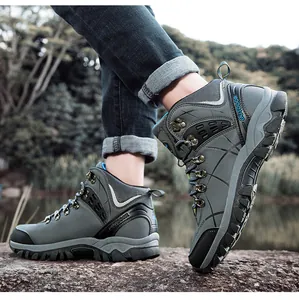 Detail of high-top hiking boots with non-slip rubber soles on rocky outdoor terrain