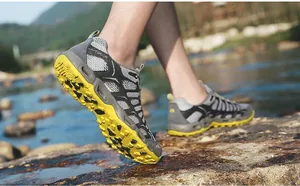 Macro detail of breathable mesh and high-traction rubber sole on outdoor wading shoes