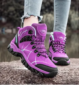Macro view of purple waterproof hiking boots with grippy rubber sole and outdoor design