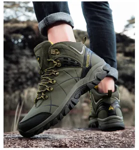 Army green high-top hiking boots for men and women on rocky terrain for outdoor camping