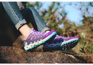 Close-up of purple and blue outdoor hiking shoes with mesh upper and rugged rubber soles