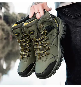 Detailed close-up of army green hiking boots with deep tread rubber soles and metal buckles